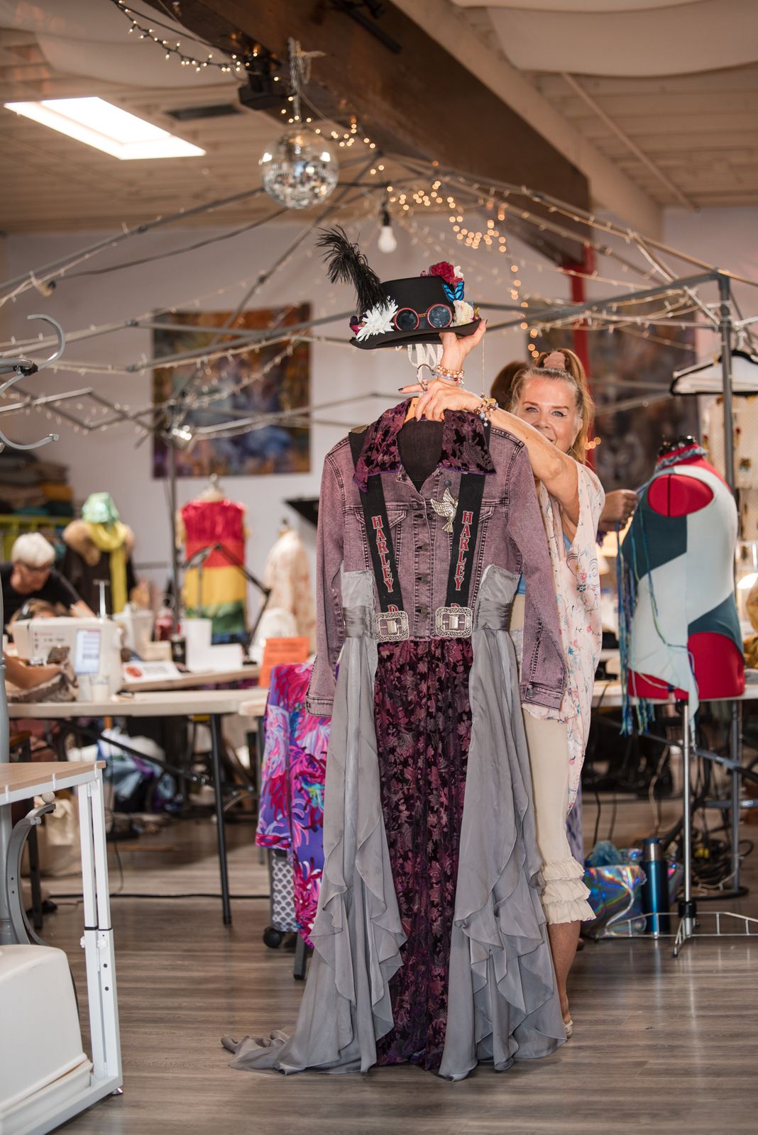 Designer finishing an upcycled lavender gown on a dress form during the Create-a-Thon